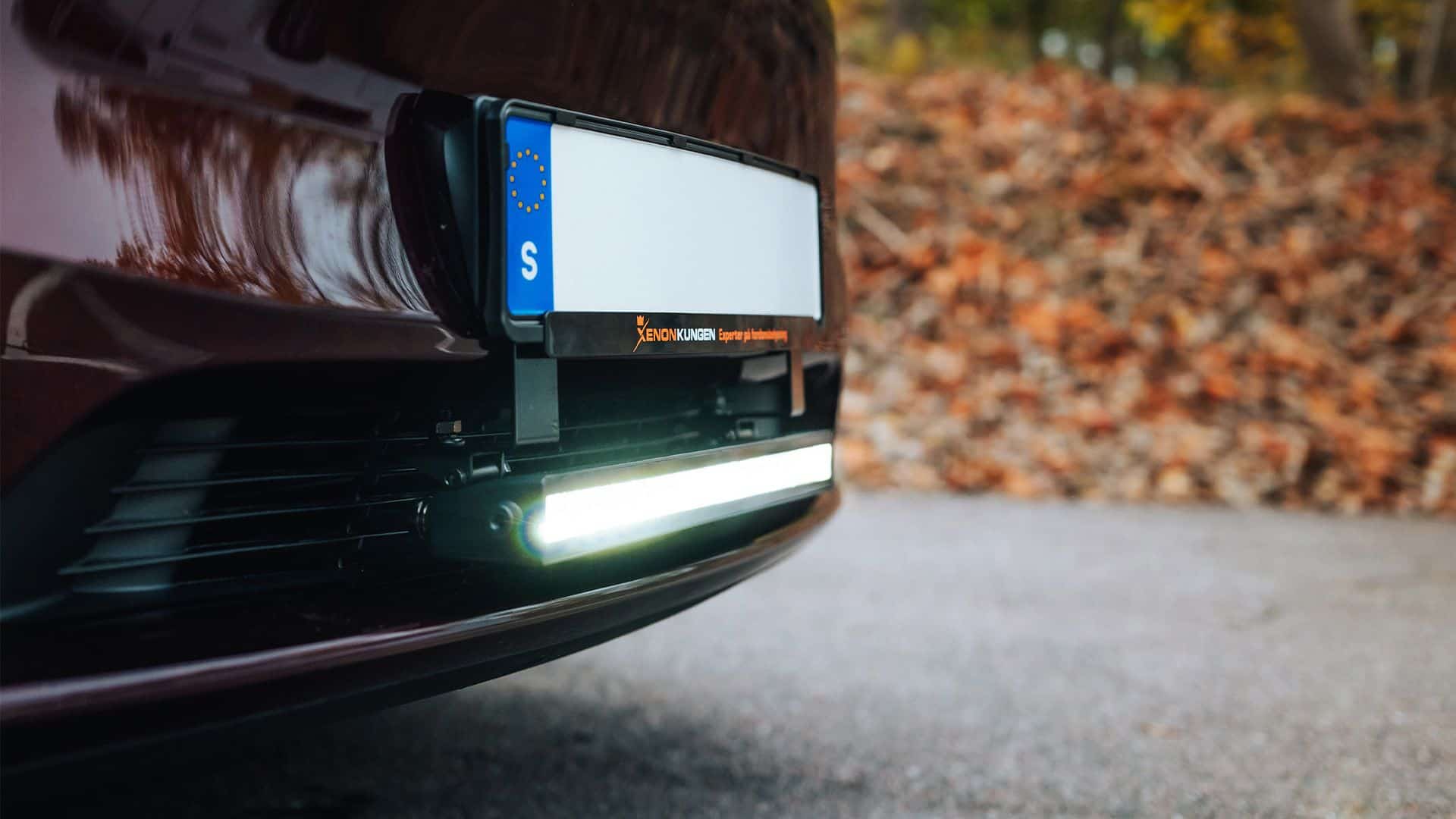 Luxtar Twilight mounted under the number plate of a Tesla